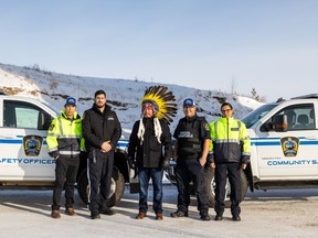 Big River First Nation Chief Jack Rayne stands with Brandon McAdam, Cody Bowman, Clayton Bear and Samantha Morin (left to right), members of the First Nation Community Service Officers pilot program.