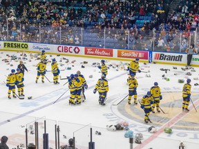 The Saskatoon Blades celebrate the first goal of the game by forward Vaughn Watterodt (18) during WHL action against the Prince Albert Raiders. The goal triggered the Teddy Bear Toss, a tradition where fans toss stuffed animals onto the ice when the Blades score their first goal. The toys are collected and donated to children in Saskatoon. Photo taken in Saskatoon on Tuesday, December 27, 2022.