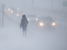 A pedestrian braves the elements as high winds blow snow and obscure visibility along Clarence Avenue. Photo taken in Saskatoon, SK on Monday, January 31, 2022.