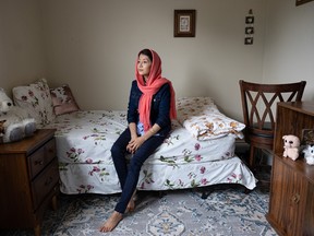 Maryam Masoomi, who came to Saskatoon from Afghanistan as a refugee after escaping the new regime’s control late last year, sits for a photo in her bedroom June 8.