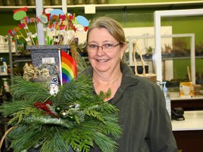 Joanne Dionne holds her Pride planter at the GreenAcres Greenhouse in Watrous, Sask. on December 14, 2022. (Julia Peterson/Saskatoon StarPhoenix)