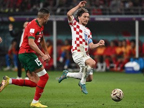 Croatia's midfielder Luka Modric, right, fights for the ball with Morocco's midfielder Selim Amallah during the Qatar 2022 World Cup third place play-off football match between Croatia and Morocco at Khalifa International Stadium in Doha on Dec. 17, 2022.