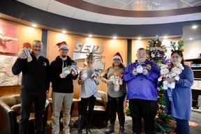 From left to right: SEIU-West members Chris Clark (trustee) Tyler Dick, Lou-Ellen Murray, Deidre Wilson, TristanBanyay and Jeanne Javinal (executive board members) posing with some of the super cute stuffies that will be givenout this holiday season through the StarPhoenix Plush Bear program. JENNIFER JACOBY-SMITH