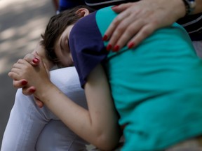 Tetyana Ponomarchuk, deputy head of social care, 61, comforts Tanya, 12, who is autistic and does not speak, at a facility for people with special needs, amid Russia's invasion of Ukraine, in Odesa, Ukraine, June 7, 2022. Tanya, like nine in 10 of the children in Ukraine's orphanage system, is a "social orphan" ? children whose parents are unable to care for them or denied parental rights under Ukrainian law.