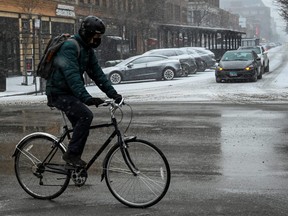 A bicyclist makes his way along Halsted Street during a cold weather front as a weather phenomenon known as a bomb cyclone hits the Upper Midwest, in Chicago, Dec. 22, 2022.
