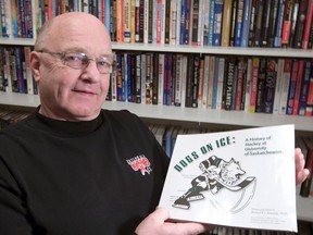 Bill Seymour with his incredible sports book collection, holding his all-time favourite on Feb. 2, 2012.