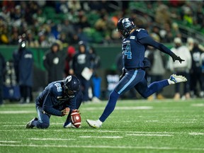 With John Haggerty holding, Toronto Argonauts kicker Boris Bede attempts a field goal in the 2022 Grey Cup game against the Winnipeg Blue Bombers at Mosaic Stadium.