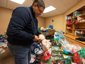 Saskatoon Tribal Council Tribal Chief Mark Arcand shows donated Christmas gifts at the new STC Wellness Centre in Fairhaven.