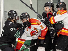 A penalized hit by Jeff Faith led to a scrum by the boards as U of S Huskies' Jaxan Kauski gets int he face of an opposing University of Calgary Dino player at Merlis Belsher Place. Photo taken in Saskatoon, Sask. on Friday, Dec. 2, 2022.