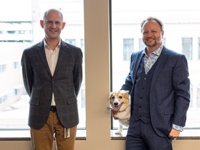 Chad Eggerman, left, and Troy Baril with Aura the dog at Procido LLP law firm, which they recently founded in the Birks Building in downtown Saskatoon.