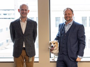 Chad Eggerman, left, and Troy Baril with Aura the dog at Procido LLP law firm, which they recently founded in the Birks Building in downtown Saskatoon.