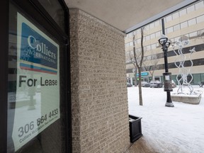 A "For Lease" sign is displayed in the window of a vacant office building in downtown Saskatoon on December 12, 2022.