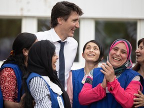 Prime Minister Justin Trudeau receives a warm welcome during his stop at the Saskatoon Open Door Society child-care centre on May 25.