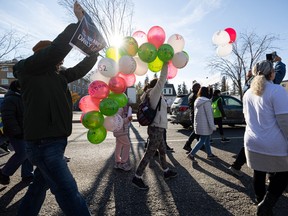 Shabnam Abddi carries balloons with messages during an Oct. 29 rally from College Drive and Wiggins Avenue to City Hall to support the freedom movement of Iranian people and women’s rights which erupted after the killing of Mahsa Amini by the morality police.