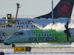An Air Canada aircraft is de-iced at Vancouver International Airport in Richmond, B.C., Wednesday, Dec. 21, 2022. A major winter storm bearing down on Toronto is adding to the calamity in Canadian airports already plagued by flight cancellations and delays set off early this week by heavy snow in Vancouver.THE CANADIAN PRESS/Darryl Dyck