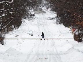 A person makes their way through the Sandy Hill neighbourhood of Ottawa, on Friday, Dec. 23, 2022.