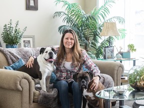 Colleen Dell sits with her dogs Molly, left, and E-jay, Jan. 5. A U of S research team led by Dell has created a pet-friendly rental housing guide for the public.
