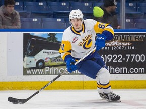 Saskatoon Blades forward Jake Chiasson (61) carries the puck up the ice during WHL action against the Portland Winterhawks in Saskatoon on Wednesday, January 11, 2023.