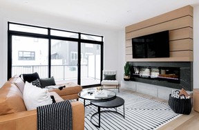 Pure Developments used three different materials — rift-cut oak panels, tile and custom-poured concrete — to create the one-of-a-kind fireplace look for the living room of its new show home at 338 Taube Green in Brighton.