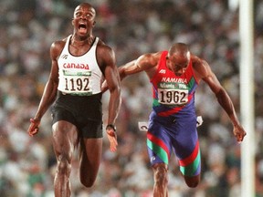 Donovan Bailey reacts at the finish line after winning 100-m gold with a world-record time at the 1996 Olympics.