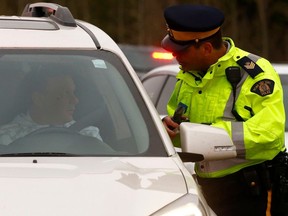 A Mountie conducts a roadside sobriety test at a checkstop leading into the Victoria Day long weekend on Highway 22 outside Bragg Creek. Thursday, May 16, 2019.