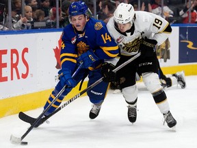 The Edmonton Oil Kings' Marshall Finnie (14) battles the Brandon Wheat Kings' Jake Chiasson (19) during second period WHL action at Rogers Place, in Edmonton Friday Nov. 18, 2022. Photo By David Bloom