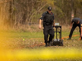 Members of the Six Nations Police conduct a search for unmarked graves using ground-penetrating radar on the 500 acres of the lands associated with the former Indian Residential School, the Mohawk Institute, in Brantford, Ont., Tuesday, November 9, 2021. It's the technology behind the discoveries of what are believed to be unmarked graves at former residential school sites -- but how much does the public understand about how ground-penetrating radar works?&ampnbsp;