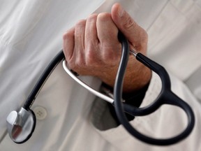 A general practitioner holds a stethoscope in this photo illustration.