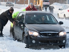 People try to help a motorist stuck in the snow in this photo from  March of 2013 in Saskatoon.