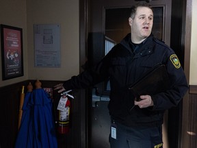 'The role has not changed': Saskatoon fire marshal explains building inspection process Fire inspector Braden Gartner points out a pair of patio umbrellas obscuring a fire alarm during an annual inspection of a Saskatoon restaurant. Inspectors will often correct easily remedied infractions on the spot — in this case, the umbrellas were moved out of the way after this photo was taken. (Saskatoon StarPhoenix / Michelle Berg)