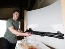 Adam Beres sets a shotgun on a rotating platform to capture it in a 360 degree image. Beres runs Cache Grab Auctions, an online auction for hunting and firearms related products. Photo taken in Saskatoon, SK on Thursday, February 16, 2023.