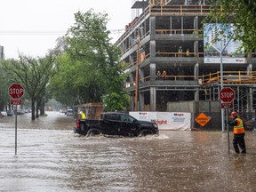 Truck drives through heavy rain and flooding in Saskatoon.