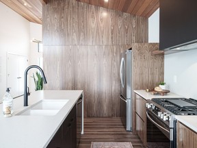A minimalist kitchen is kept sleek and clutter-free with a secret wall panel that reveals a large walk-in pantry. SCOTT PROKOP PHOTOGRAPHY