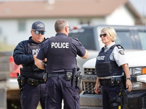 Royal Canadian Mounted Police (RCMP) officers at James Smith Cree Nation talk after multiple people were killed and injured in a stabbing spree on the reserve and nearby town of Weldon, Saskatchewan, Canada September 5, 2022.  REUTERS/David Stobbe