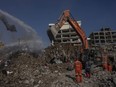 Excavators work at the site of buildings that collapsed during the earthquake in Kahramanmaras, Turkey, Friday, Feb. 17, 2023.