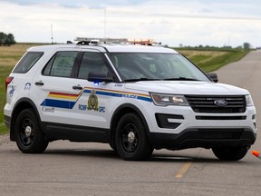 An RCMP cruiser is parked on a highway near Regina in June of 2021.