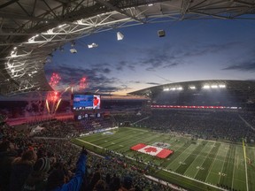 The Canadian Flag is held over the field as the national anthem is played during the 109th Grey Cup at Mosaic Stadium on Sunday, November 20, 2022 in Regina. KAYLE NEIS / Regina Leader-Post