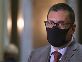 Paul Merriman, Saskatchewan's health minister, speaks to media after the throne speech at the Legislative Building in Regina on Wednesday Oct. 27, 2021. Documents show employees in the federal departments were surprised when Merriman sent a letter in October 2021 requesting help during the height of the fourth wave of the COVID-19 pandemic..