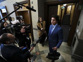 Prime Minister Justin Trudeau talks to reporters in the foyer as he arrives for question period in the House of Commons on Parliament Hill in Ottawa on Monday, Feb. 6, 2023. Trudeau is joining Canada's premiers at the table today where he is set to offer them a significant increase towards health-care funding.