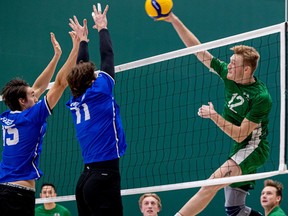 U of S Huskies' graduating middle player Quinn Buchanan hammers the ball against UBC-Okanagan Heat in Canada West men's volleyball action at the PAC. Photo taken in Saskatoon on Friday, Dec. 2, 2022.