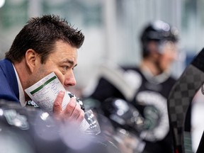 U of S Huskies' head coach Brandin Cote on the bench during a game against the University of Calgary Dinos in Canada West men's hockey action at Merlis Belsher Place. Photo taken in Saskatoon, Sask. on Friday, Dec. 2, 2022.