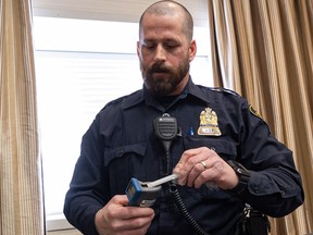 Saskatoon police Const. Foster shows two of the roadside devices used to detect alcohol and cannabis use in impaired drivers.