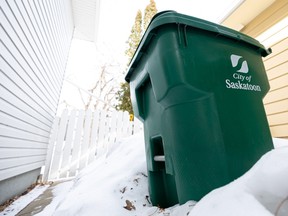 City of Saskatoon green carts sit in a snow pile. The program will be up and running citywide this year. Photo taken in Saskatoon, Sask. on Tuesday, March 7, 2023.