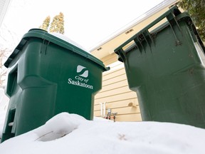 City of Saskatoon green carts sit in a snow pile. Photo taken in Saskatoon, Sask. on Tuesday, March 7, 2023.