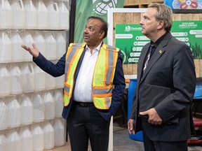 Bob Behari, president and CEO of EnviroWay, speaks with MLA Ken Cheveldayoff after an announcement about labour force statistics at EnviroWay Detergent Manufacturing Inc. in Saskatoon on Thursday, March 9, 2023.