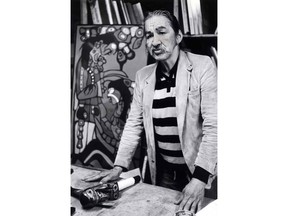 Indigenous artist Norval Morrisseau says he is heppy sketching in the streets of Vancouver as he poses in front of one of his earlier paintings at a Vancouver gallery on Monday, May 11, 1987. The OPP say they have been investigating alleged fraudulent art that is being made and sold under Morrisseau's name.