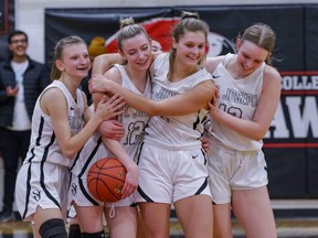 With the clock still ticking down but the ball in their possession in the final few seconds, the St. Joseph Guardian celebrate their impending city title. Photo by Colin Chatfield.