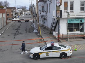 Police tape cordons off the scene after a Quebec provincial police officer was killed while trying to arrest a man in Louiseville, Que., March 28.