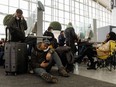 Transport Minister Omar Alghabra says the federal government will close a loophole that allows airlines to deny customers compensation for cancelled flights. Travellers wait on hold as they try and speak with their respective airlines at Toronto Pearson International Airport, as a major winter storm disrupts flights in and out of the airport, in Toronto, Saturday, Dec. 24, 2022.