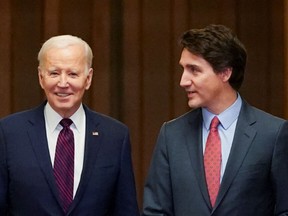 U.S. President Joe Biden walks with Canadian Prime Minister Justin Trudeau in Ottawa on March 24, 2023.